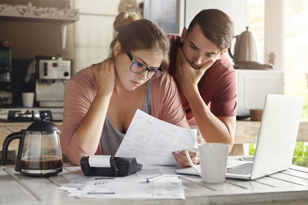 couple look at their debt